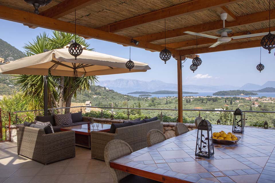 Outdoor dining table and fire table overlooking Ionian Islands to mainland Greece