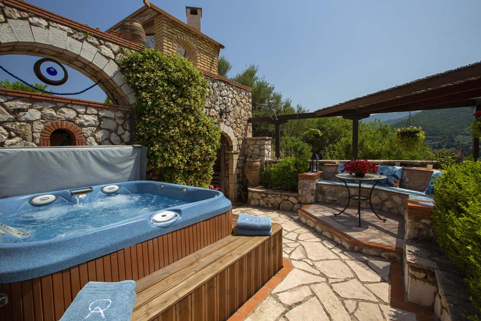 Jacuzzi and seating by day night at Villa Octavius