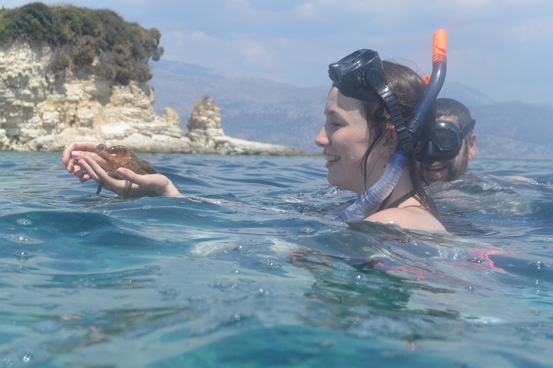 Guest discovering a starfish on Marine Adventure trip